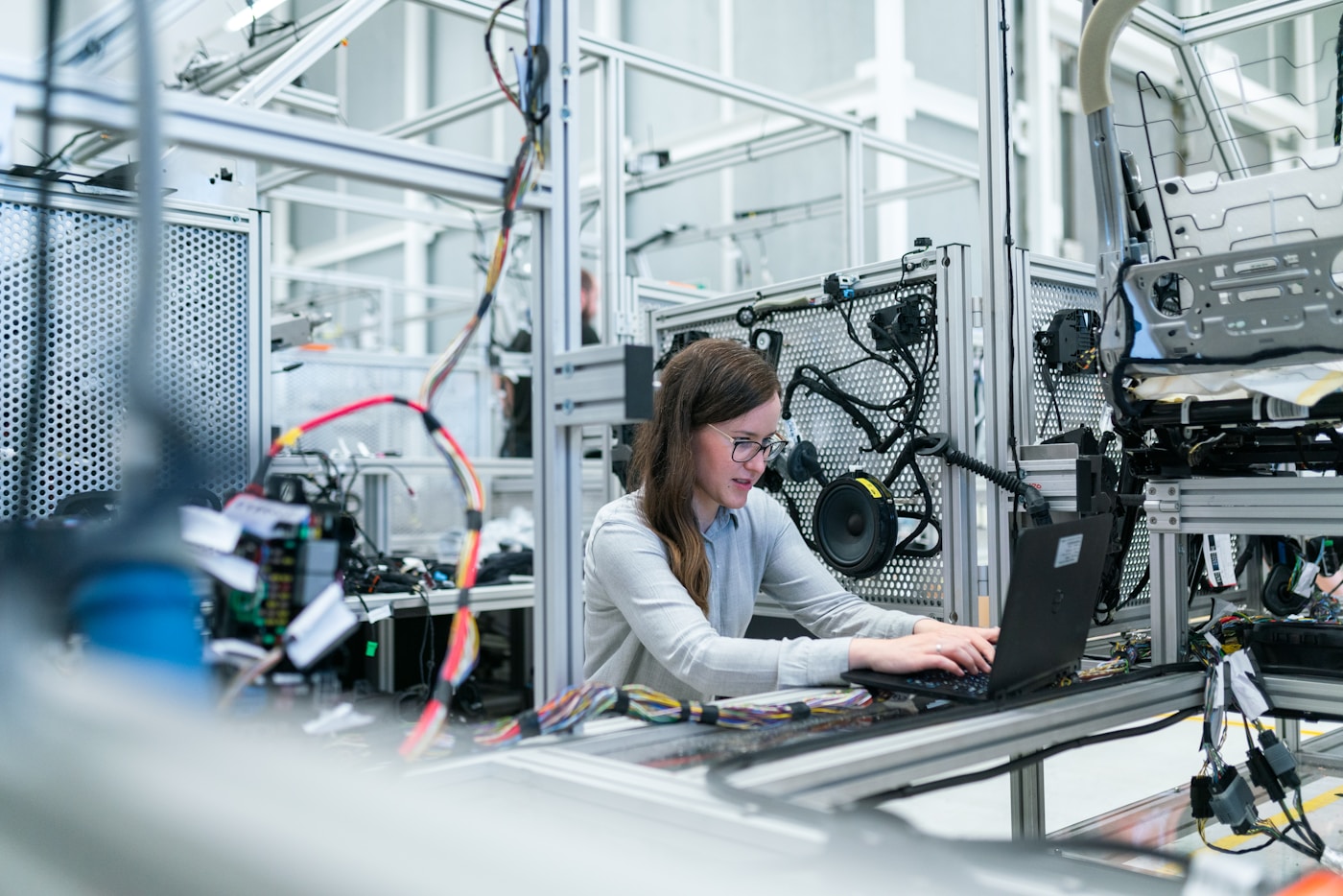 Engineer working on a laptop in a modern IT lab