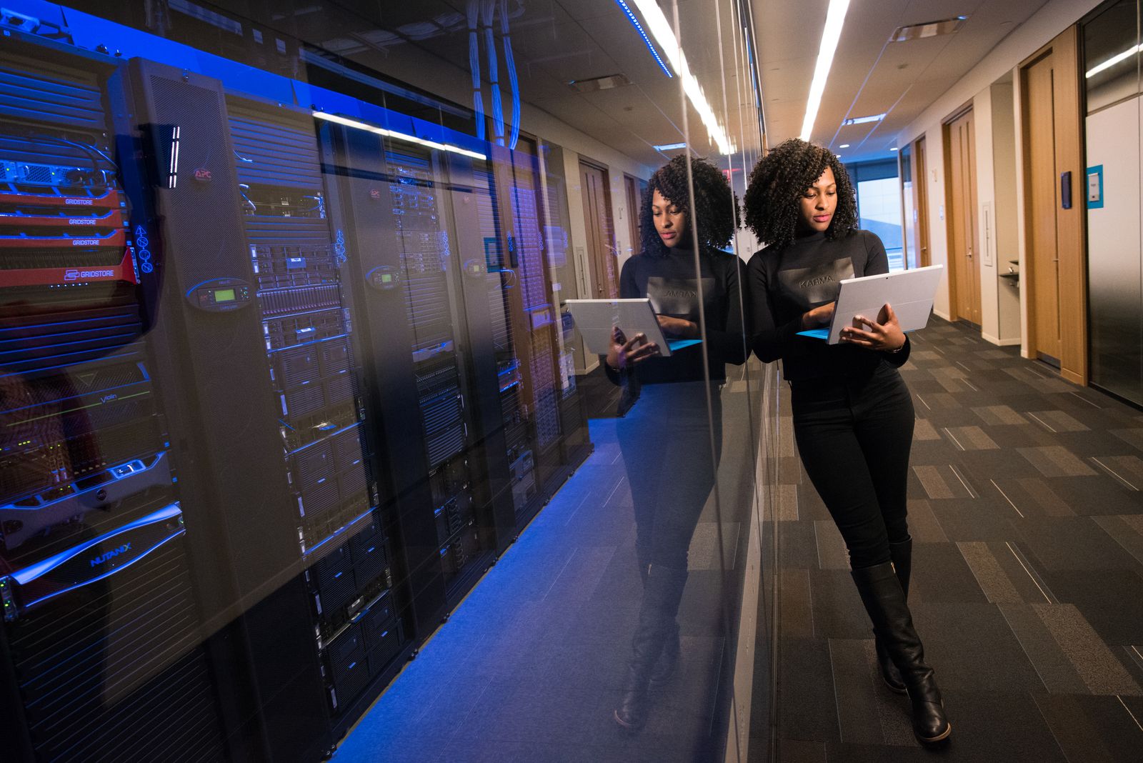 Engineer reviewing systems beside a modern server room